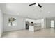 Modern, open-concept kitchen with white cabinets, stainless steel appliances, and a central island at 4146 New Milford St, North Port, FL 34288