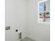 Well-lit laundry room featuring modern connections, a window, and neutral wall color at 4146 New Milford St, North Port, FL 34288