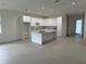 Spacious living area featuring a seamlessly integrated kitchen with modern cabinets and island at 4146 New Milford St, North Port, FL 34288