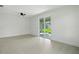 Open living room with large sliding glass doors leading to outdoor area with lots of natural light at 4146 New Milford St, North Port, FL 34288