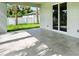 Picturesque patio with gray tile flooring and a lovely view of the manicured backyard at 4146 New Milford St, North Port, FL 34288