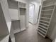 Spacious walk-in closet with built-in shelving and ample storage, leading to a bright, modern bathroom at 4146 New Milford St, North Port, FL 34288
