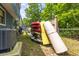 Exterior of property featuring stacked kayaks and canoes, alongside a ladder and AC unit at 5375 Circle Dr, Weeki Wachee, FL 34607