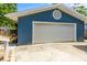 Attached garage with a white door and concrete driveway at 5375 Circle Dr, Weeki Wachee, FL 34607
