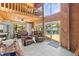 Cozy living room with a wood vaulted ceiling, large windows, tile floor, and access to the deck at 5375 Circle Dr, Weeki Wachee, FL 34607
