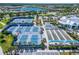 Aerial view of the community's tennis, pickleball, and bocce ball courts surrounded by lush landscaping at 5820 Shorebird Br, Land O Lakes, FL 34638
