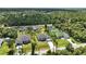 Aerial view pinpointing location amidst a residential neighborhood, showcasing the lot size and tree coverage at 4098 New Milford St, North Port, FL 34288