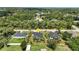 Aerial view of the home and neighborhood surrounded by lush mature trees with location pin at 4098 New Milford St, North Port, FL 34288