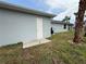 Backyard of a house featuring a white exterior and well-maintained lawn at 4098 New Milford St, North Port, FL 34288