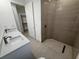 Modern bathroom with a double sink vanity and stylish tiled shower at 4098 New Milford St, North Port, FL 34288