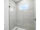 Stylish bathroom featuring a glass shower enclosure with sleek fixtures and tiled walls at 4098 New Milford St, North Port, FL 34288