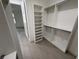 Large walk-in closet features built-in shelving and rods at 4098 New Milford St, North Port, FL 34288