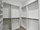 Walk-in closet featuring custom shelving with ample space for organization at 4098 New Milford St, North Port, FL 34288