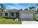 Charming single-story home with a well-manicured lawn and a two car attached garage at 4098 New Milford St, North Port, FL 34288