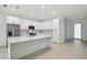 Modern kitchen features white cabinets, stainless steel appliances, and a large center island at 4098 New Milford St, North Port, FL 34288
