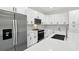 Close-up view of kitchen with stainless steel refrigerator and matching oven at 4098 New Milford St, North Port, FL 34288