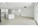 Open-concept kitchen flows into living area with light flooring and many lights at 4098 New Milford St, North Port, FL 34288