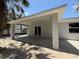 Large, covered patio with new tile flooring and sliding glass doors at 4098 New Milford St, North Port, FL 34288