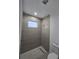 Contemporary shower with gray tiling and a sleek shower head at 4098 New Milford St, North Port, FL 34288