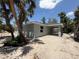 Side view of new construction featuring a covered patio and a fresh, modern design at 4098 New Milford St, North Port, FL 34288