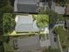 Aerial view of a home with well-manicured yard, mature shade tree, and neighboring properties at 19713 Ellendale Dr, Land O Lakes, FL 34638