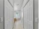 Bright bathroom featuring tile floors, a soaking tub under an arch window, and a separate glass-enclosed shower at 19713 Ellendale Dr, Land O Lakes, FL 34638