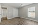 Neutral bedroom with laminate floors, closet, and bright window at 19713 Ellendale Dr, Land O Lakes, FL 34638