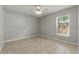 Bright bedroom with tiled floors, ceiling fan, and large window with blinds at 19713 Ellendale Dr, Land O Lakes, FL 34638
