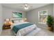 Bedroom with a bed, rug, plants, and bright window with blinds at 19713 Ellendale Dr, Land O Lakes, FL 34638