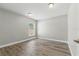 Unfurnished bedroom featuring neutral paint, laminate floors, natural light, and a modern door handle at 19713 Ellendale Dr, Land O Lakes, FL 34638