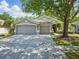 Charming single-story home with a three-car garage and mature trees at 19713 Ellendale Dr, Land O Lakes, FL 34638