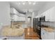 Open-concept kitchen with granite countertops, stainless appliances, and an eat-in island, adjoined to the main living space at 19713 Ellendale Dr, Land O Lakes, FL 34638