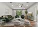Open-concept living room boasts hardwood floors, green furniture, view of exterior, recessed lighting and ceiling fan at 19713 Ellendale Dr, Land O Lakes, FL 34638
