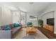 Bright living room with hardwood floors, gray sofa and blue accent pillows, and a large painting above a side table at 19713 Ellendale Dr, Land O Lakes, FL 34638
