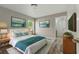 This main bedroom features stylish decor, comfortable bedding, and ample natural light at 19713 Ellendale Dr, Land O Lakes, FL 34638