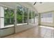 Bright sunroom with tiled floor and many large windows showcasing outdoor views at 19713 Ellendale Dr, Land O Lakes, FL 34638