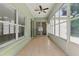 This light-filled sunroom features tiled floor and access to the backyard at 19713 Ellendale Dr, Land O Lakes, FL 34638