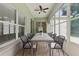 Enjoy indoor/outdoor living in this sunroom with dining set and fan at 19713 Ellendale Dr, Land O Lakes, FL 34638