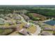 An aerial view of a well-planned community showcasing its houses, street layout, and proximity to nature, promoting outdoor lifestyle at 13475 Crest Lake Dr, Hudson, FL 34669