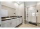 Modern bathroom offers double sinks, granite countertops, and a glass-enclosed shower at 13475 Crest Lake Dr, Hudson, FL 34669