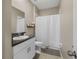 Cozy bathroom with a shower, white vanity with granite countertop, and neutral wall color at 13475 Crest Lake Dr, Hudson, FL 34669