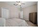 Bright bedroom featuring hardwood floors, ceiling fan, and plenty of natural light at 13475 Crest Lake Dr, Hudson, FL 34669