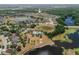 An aerial view that captures the expansive layout of a community with a pool, ponds and scenic views at 13475 Crest Lake Dr, Hudson, FL 34669