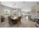 Open-concept dining room features tile floors, modern pendant lights, and seamless transition to the living area at 13475 Crest Lake Dr, Hudson, FL 34669
