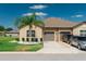 Charming home featuring a well-manicured lawn, two-car garage, and tasteful landscaping at 13475 Crest Lake Dr, Hudson, FL 34669