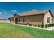 Exterior of the home featuring a lush green lawn and meticulous landscaping at 13475 Crest Lake Dr, Hudson, FL 34669