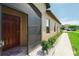Inviting front entry with a screened door and well-maintained landscaping at 13475 Crest Lake Dr, Hudson, FL 34669