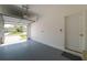 Clean garage with epoxy flooring, providing a functional space with an open door at 13475 Crest Lake Dr, Hudson, FL 34669