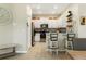 Modern kitchen boasts white cabinetry, stainless steel appliances, breakfast bar seating, and tiled floors at 13475 Crest Lake Dr, Hudson, FL 34669