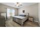 Bright bedroom boasts stylish decor, wood-look floors, and ample natural light at 13475 Crest Lake Dr, Hudson, FL 34669